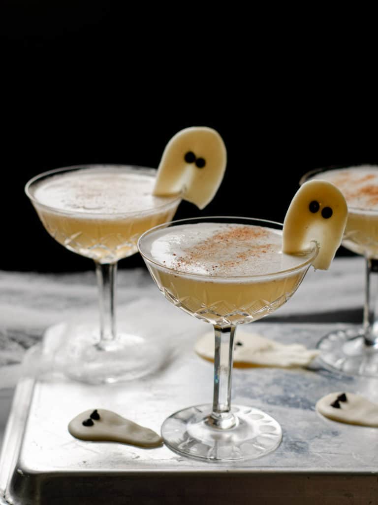 Two halloween cocktails with white chocolate casper ghosts