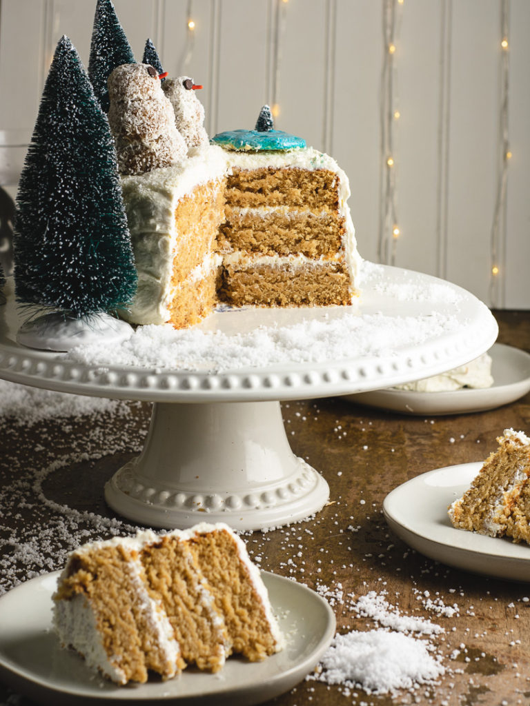 Slices of the vegan coconut cake and the whole cake with snow man on top!