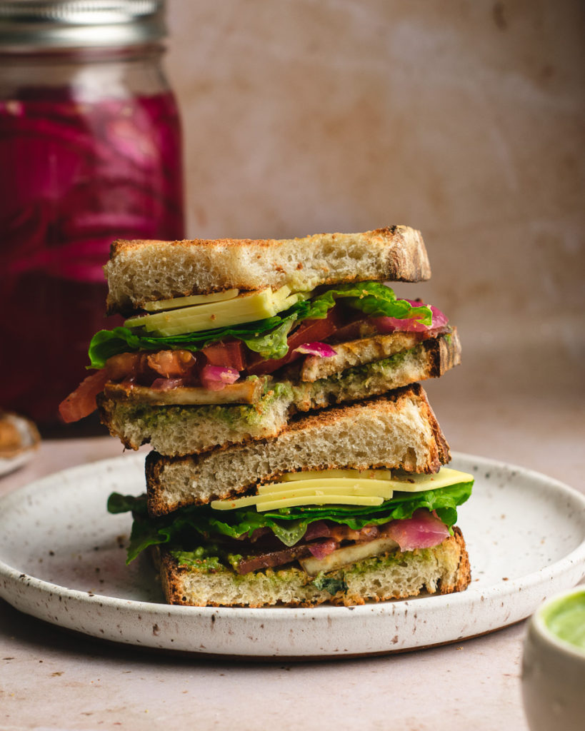 Big BLT sandwich sliced and stack showing the colorful ingredient's inside.