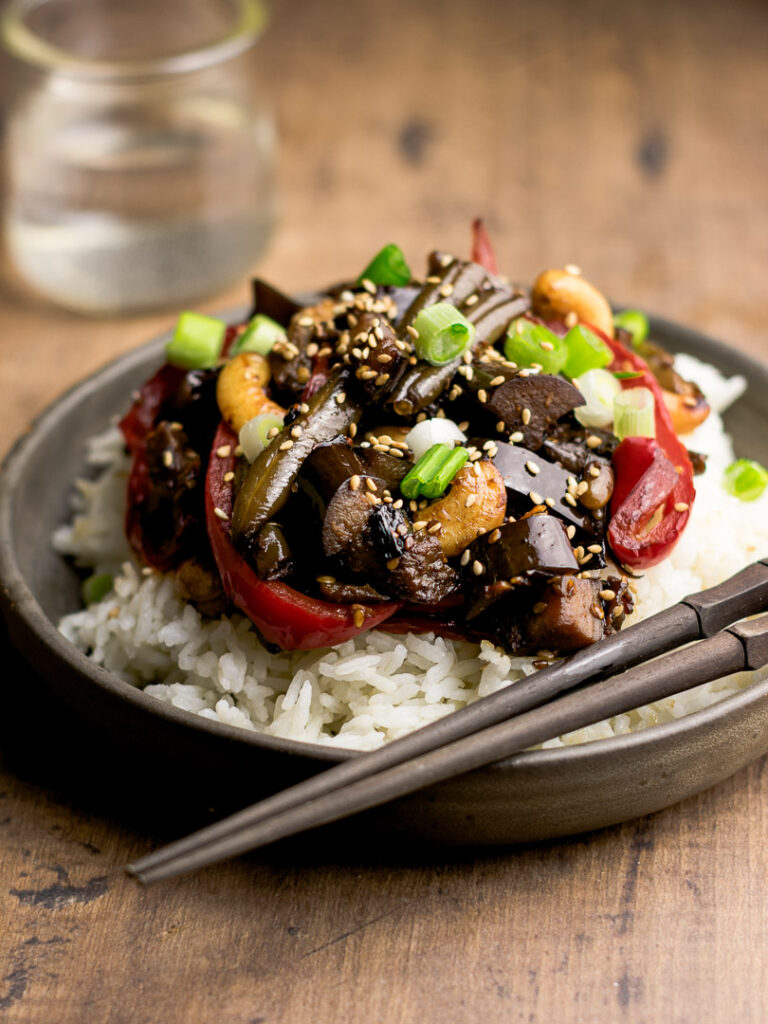 close up shot of eggplant stirfry with a sticky sweet sauce. 