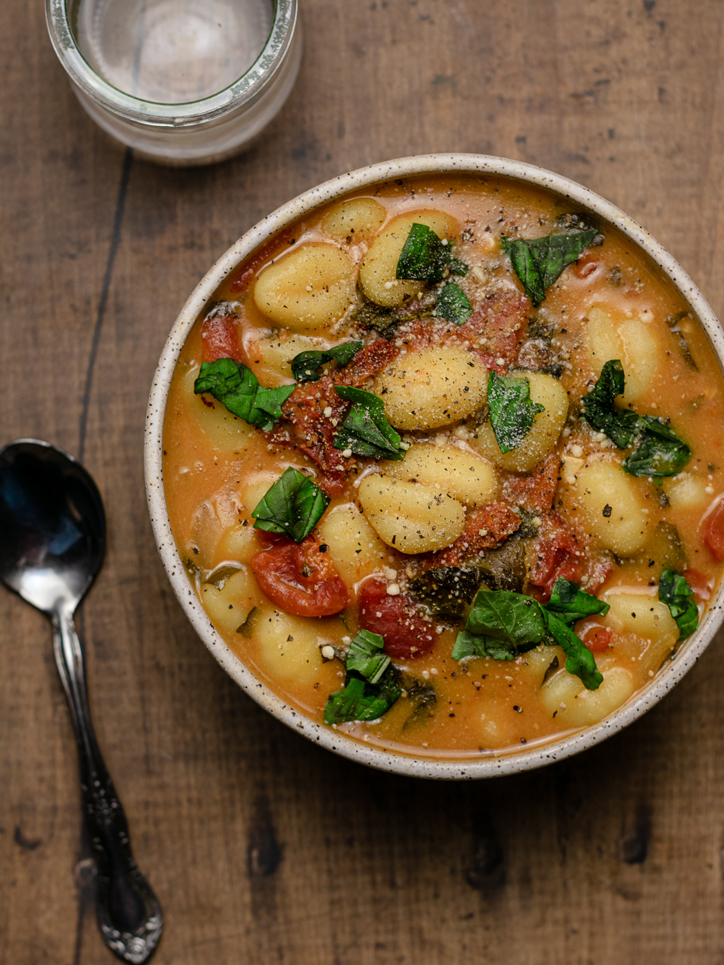 bowl of tomato gnocchi soup with fresh basil