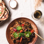 Table with fresh naan and a big bowl of vegetarian curry